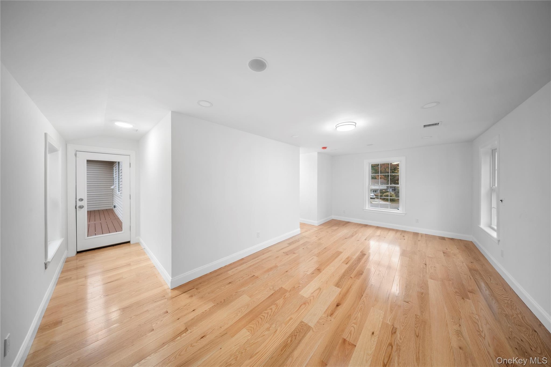 Empty room featuring baseboards and light wood-style flooring