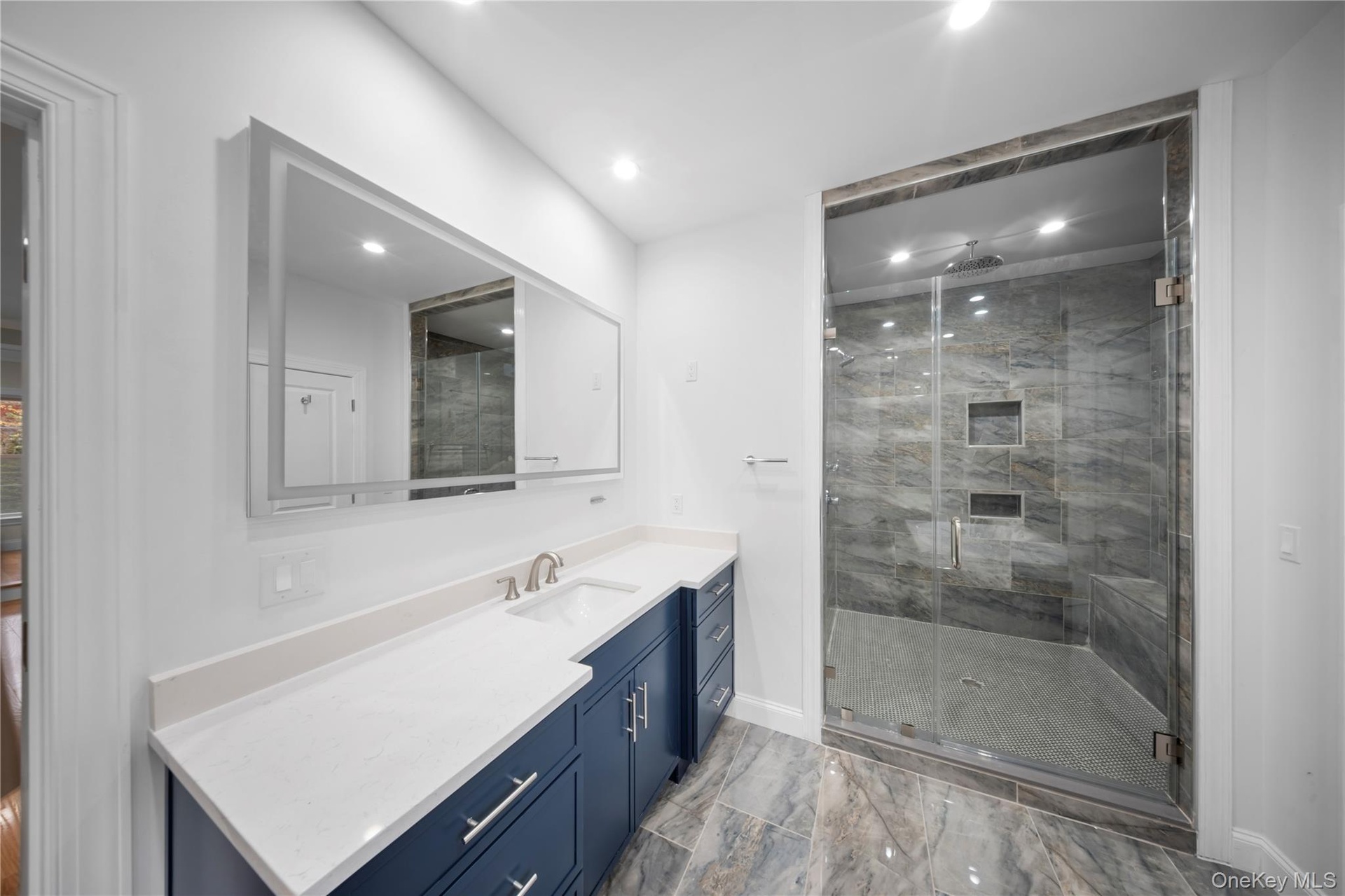 Full bathroom with vanity, a stall shower, recessed lighting, and light marble finish flooring