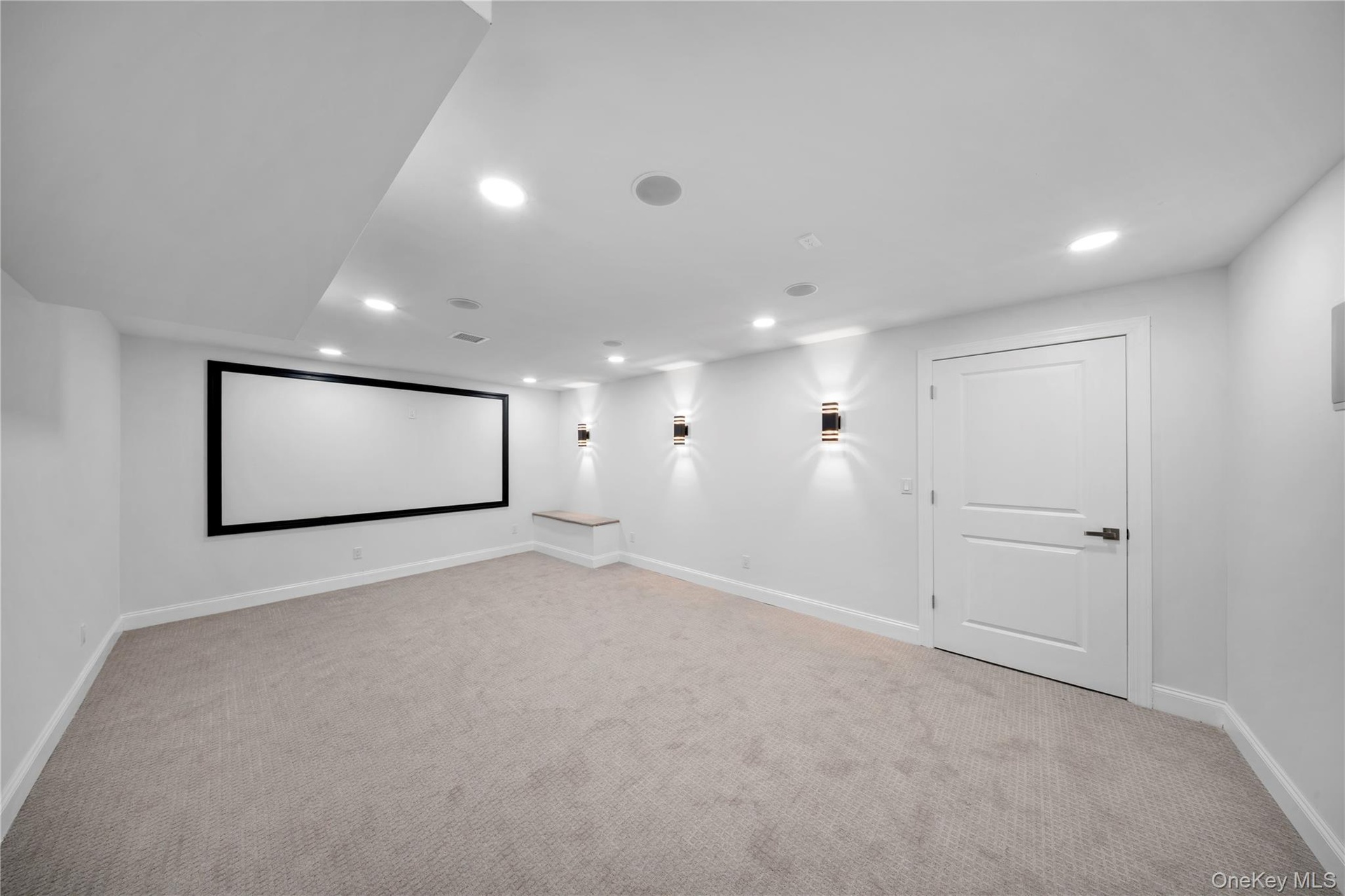 Cinema featuring light carpet and recessed lighting
