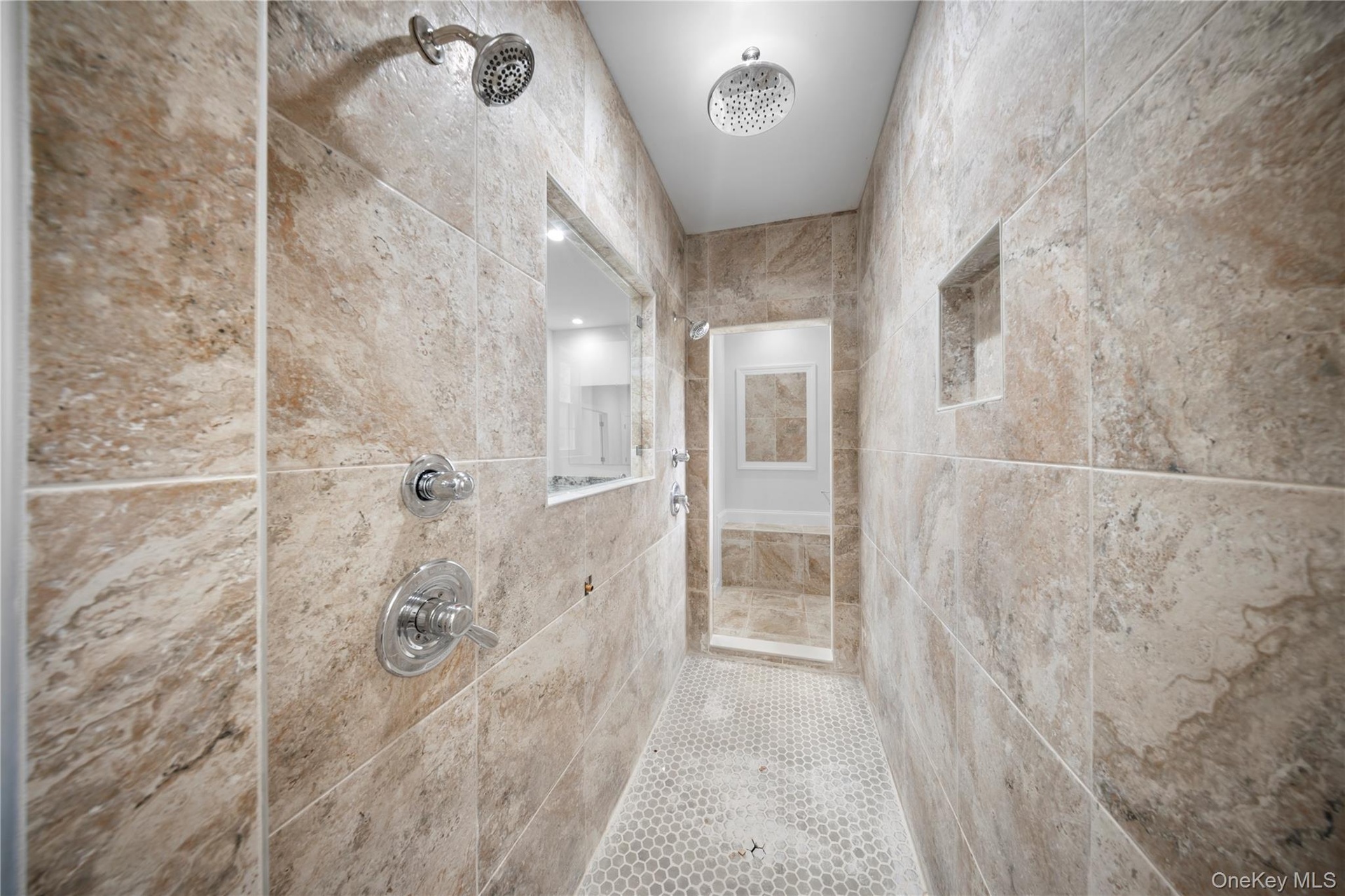 Full bath with a tile shower and tile walls