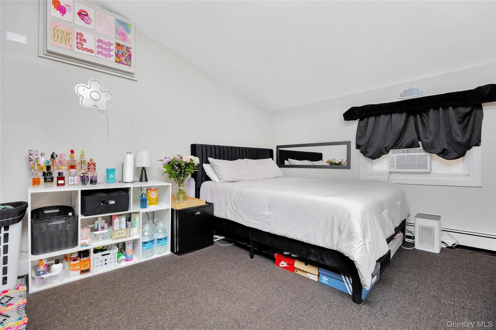 Carpeted bedroom featuring vaulted ceiling
