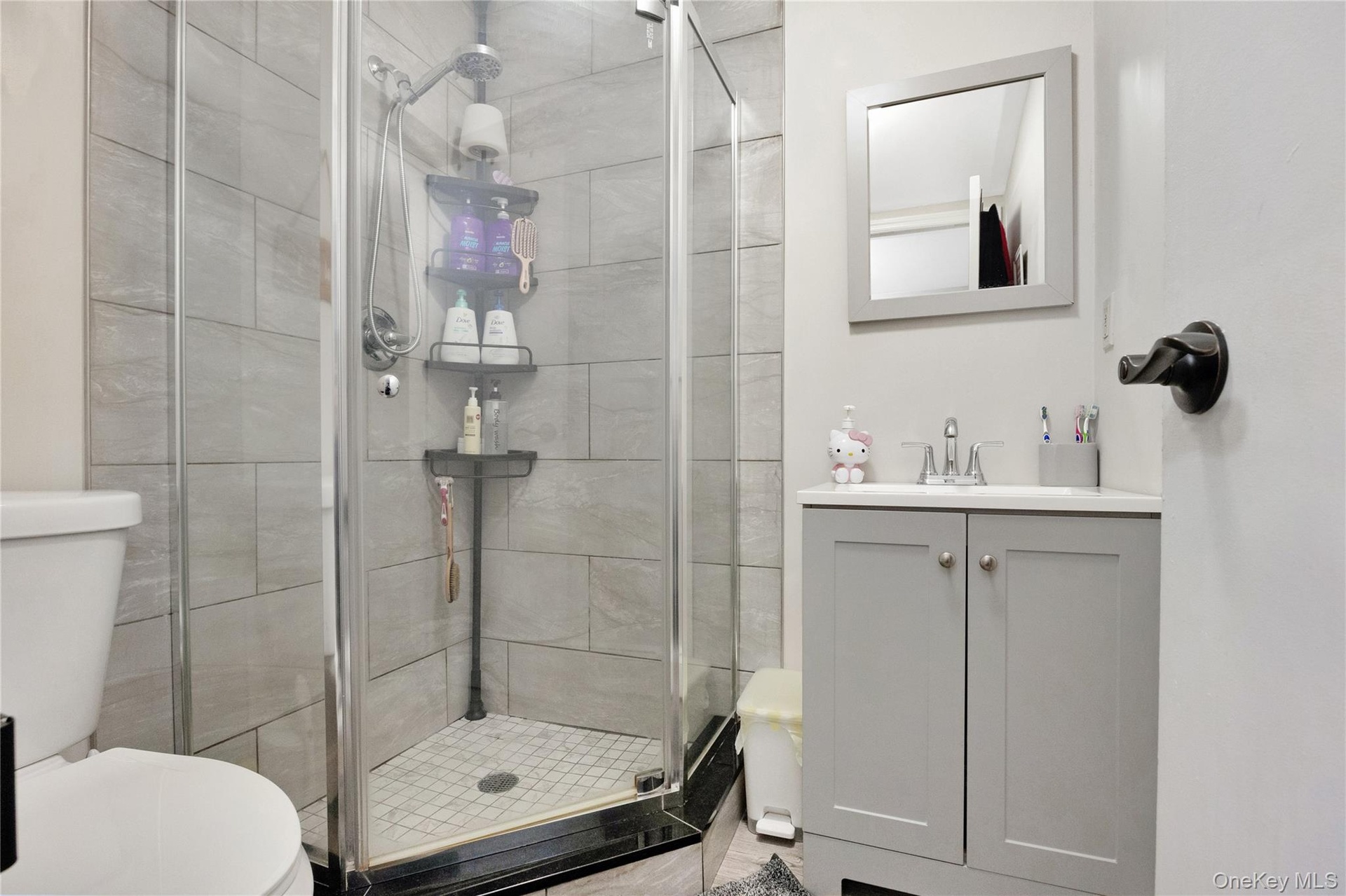 Bathroom with a stall shower and vanity