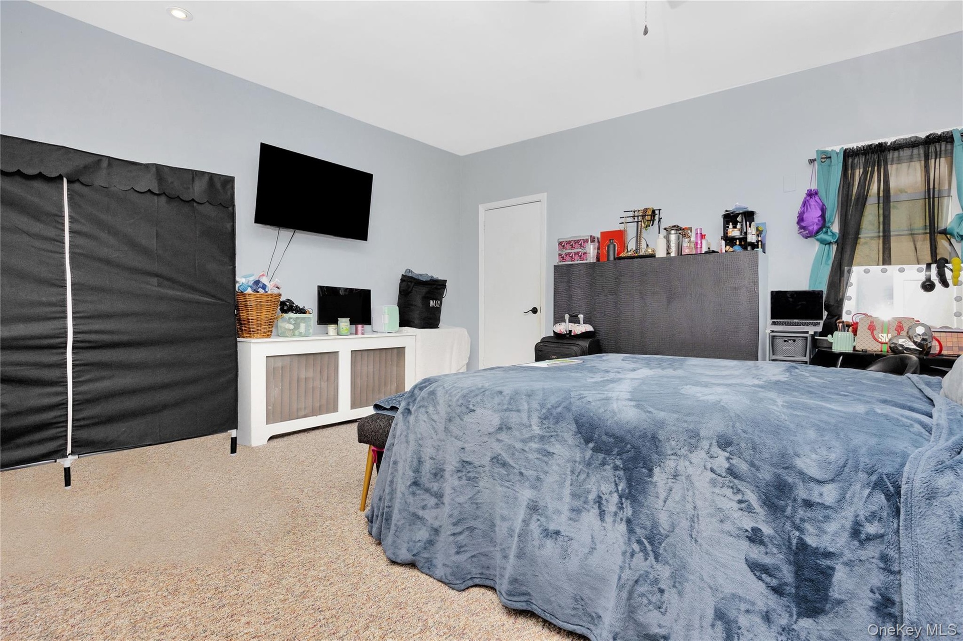 Carpeted bedroom with recessed lighting