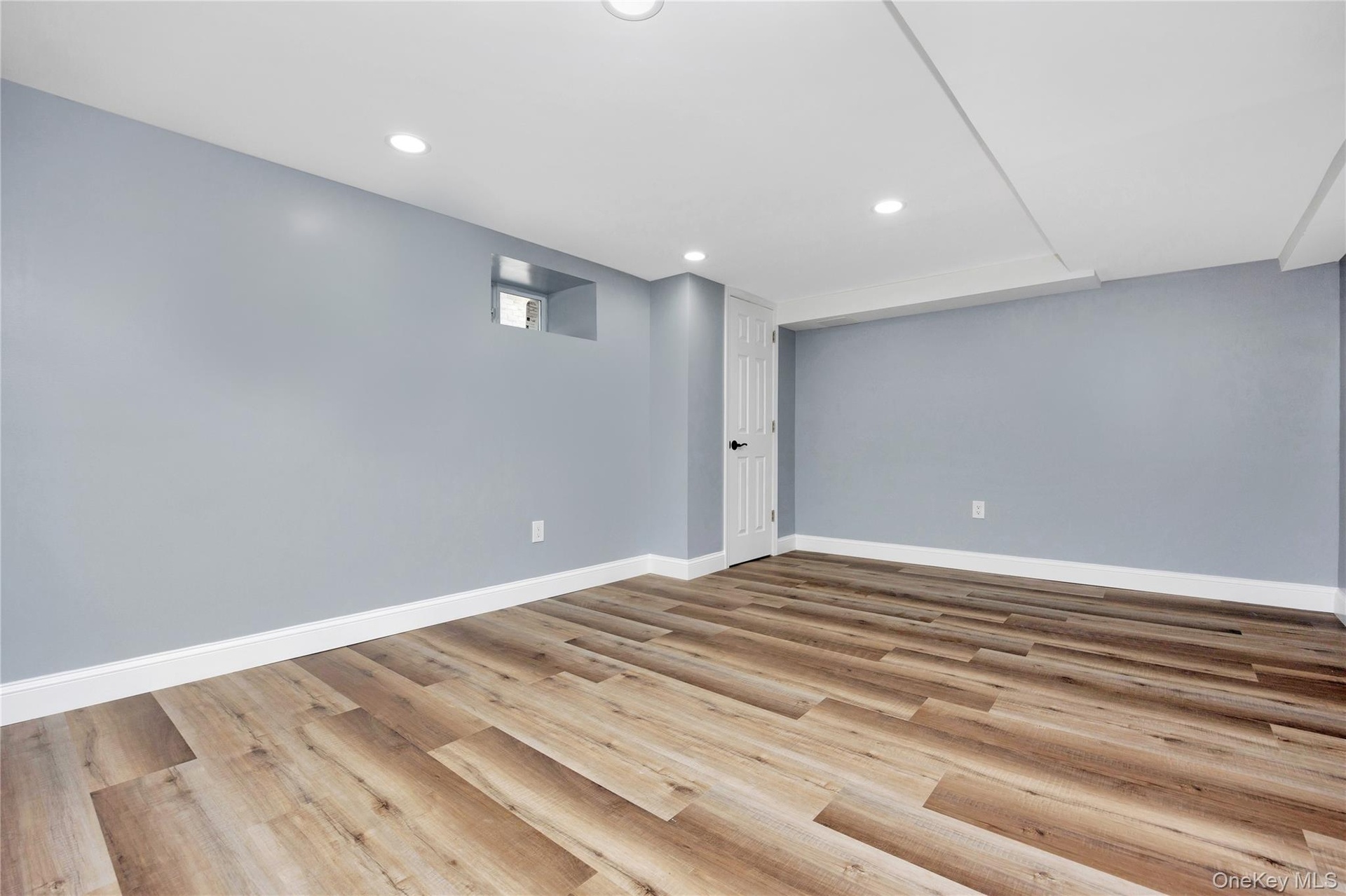 Finished basement with recessed lighting and wood finished floors