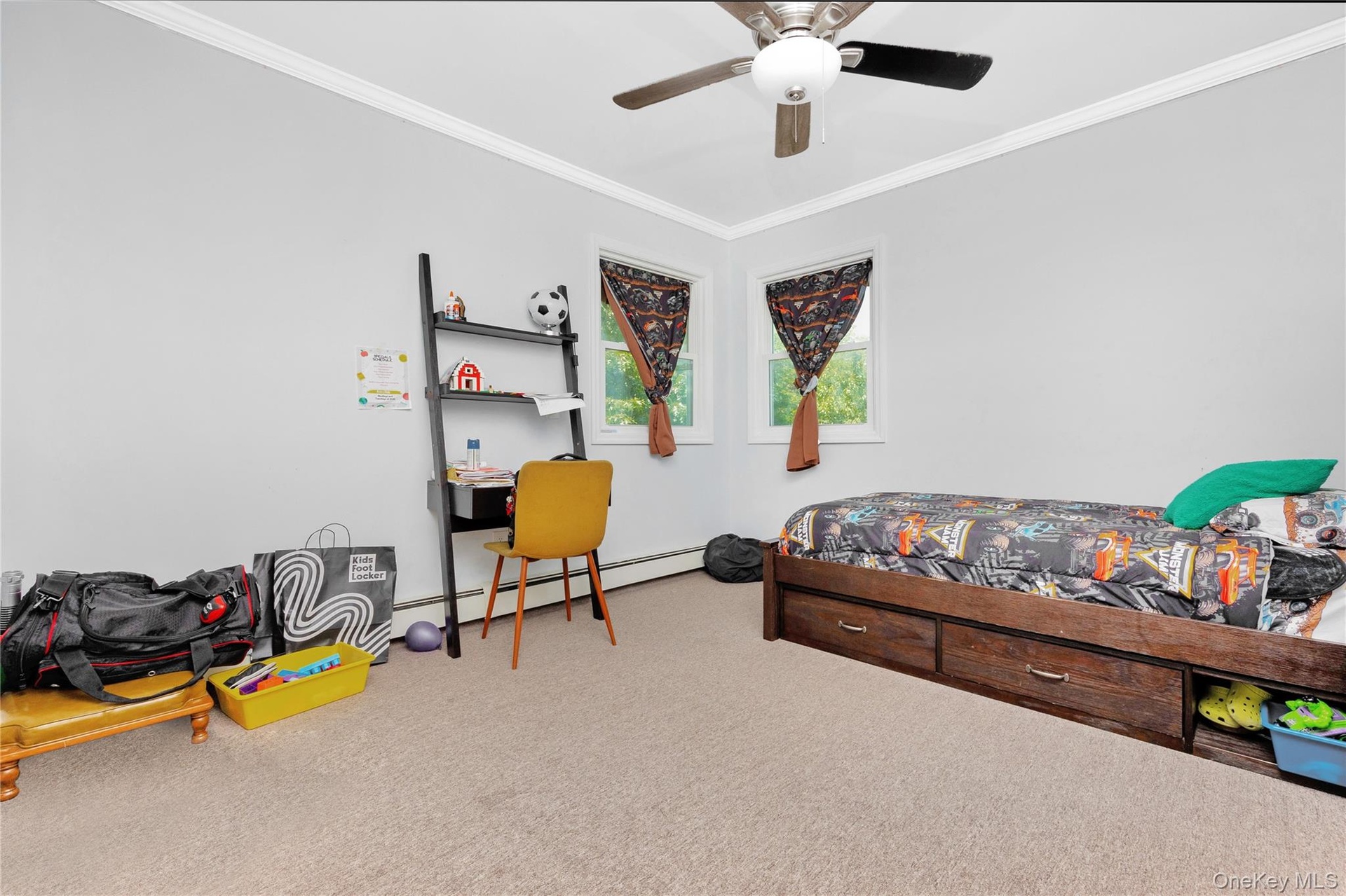 Bedroom with ornamental molding, a baseboard radiator, carpet floors, and a ceiling fan