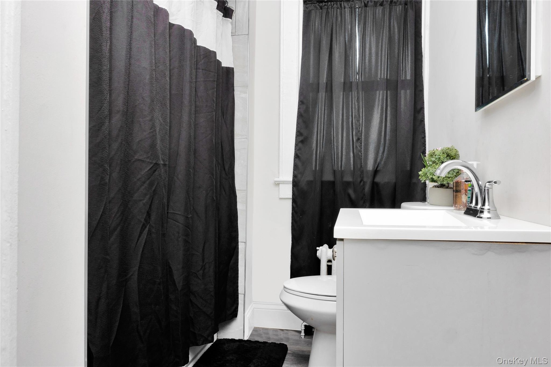 Full bath with vanity and a shower with shower curtain