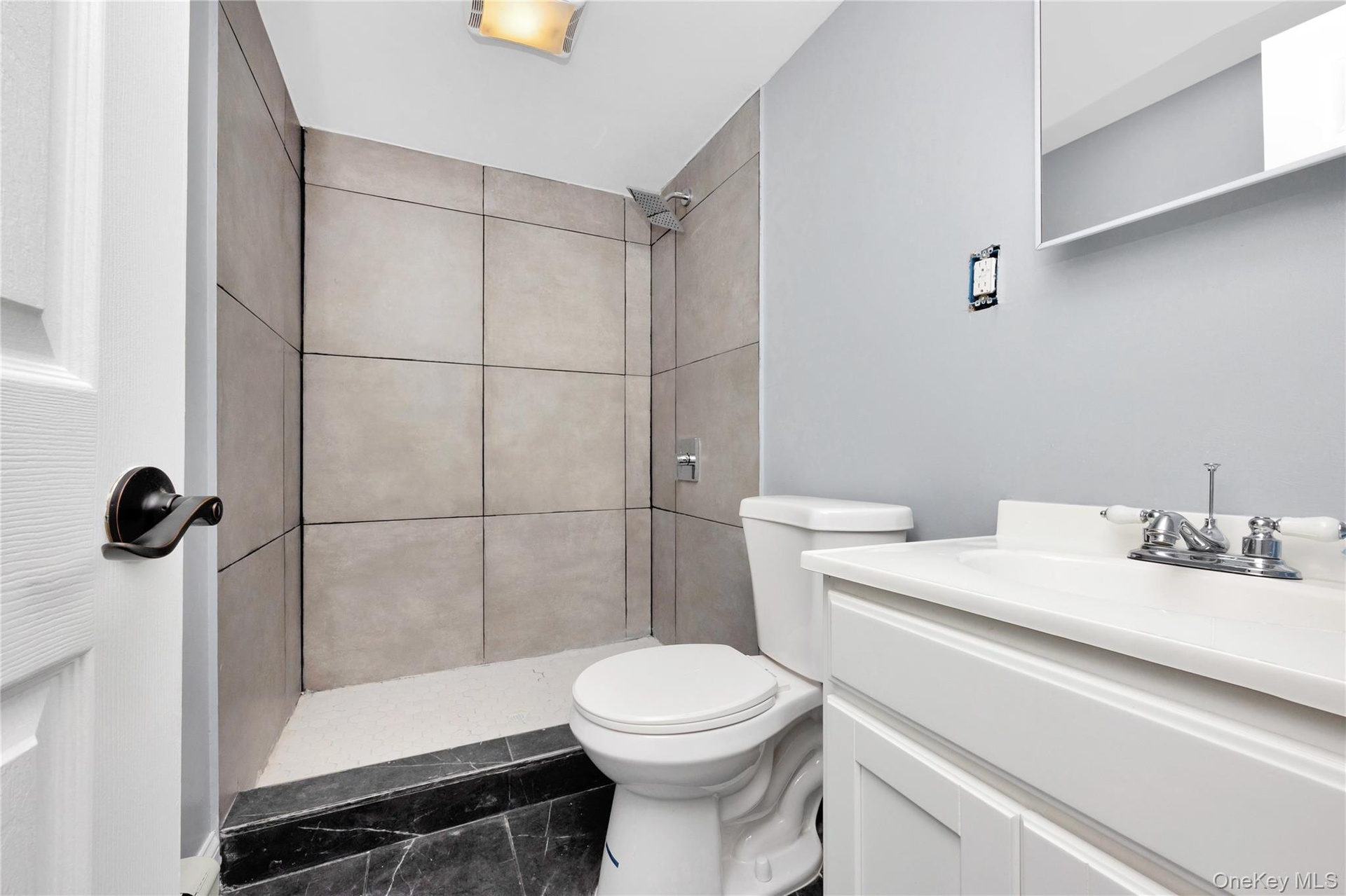 Bathroom featuring vanity and a tile shower