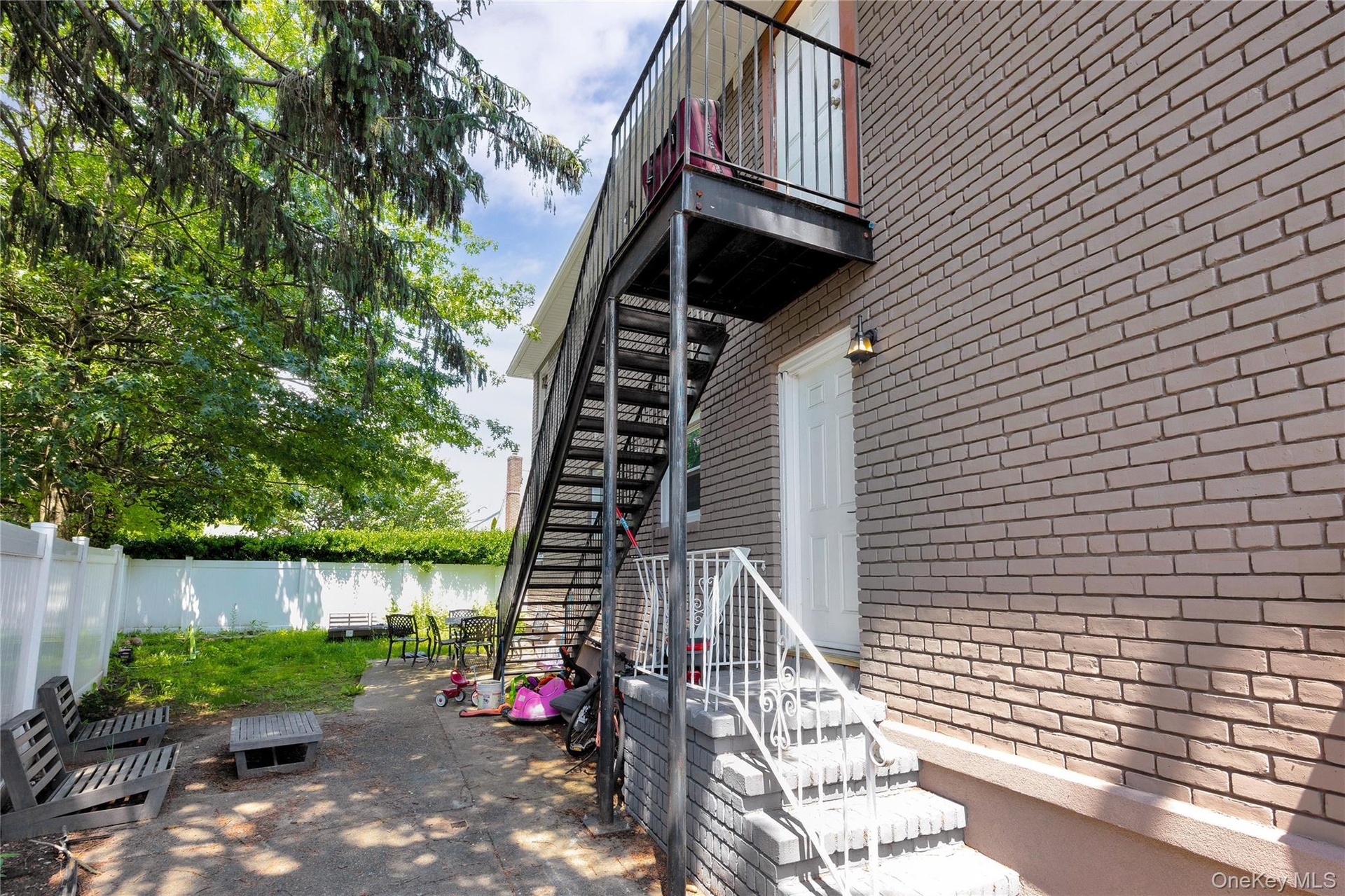 Patio / terrace with stairs, a patio, and a water view
