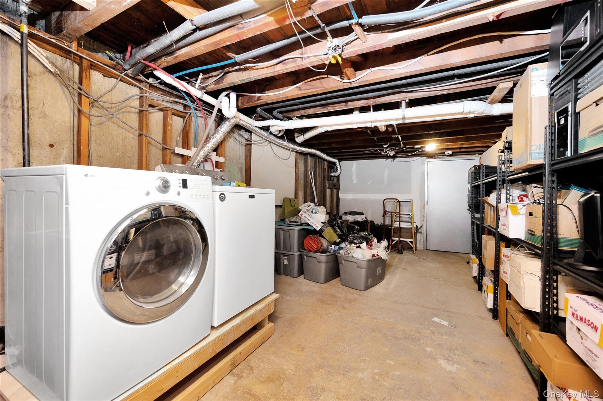 Unfinished below grade area with independent washer and dryer