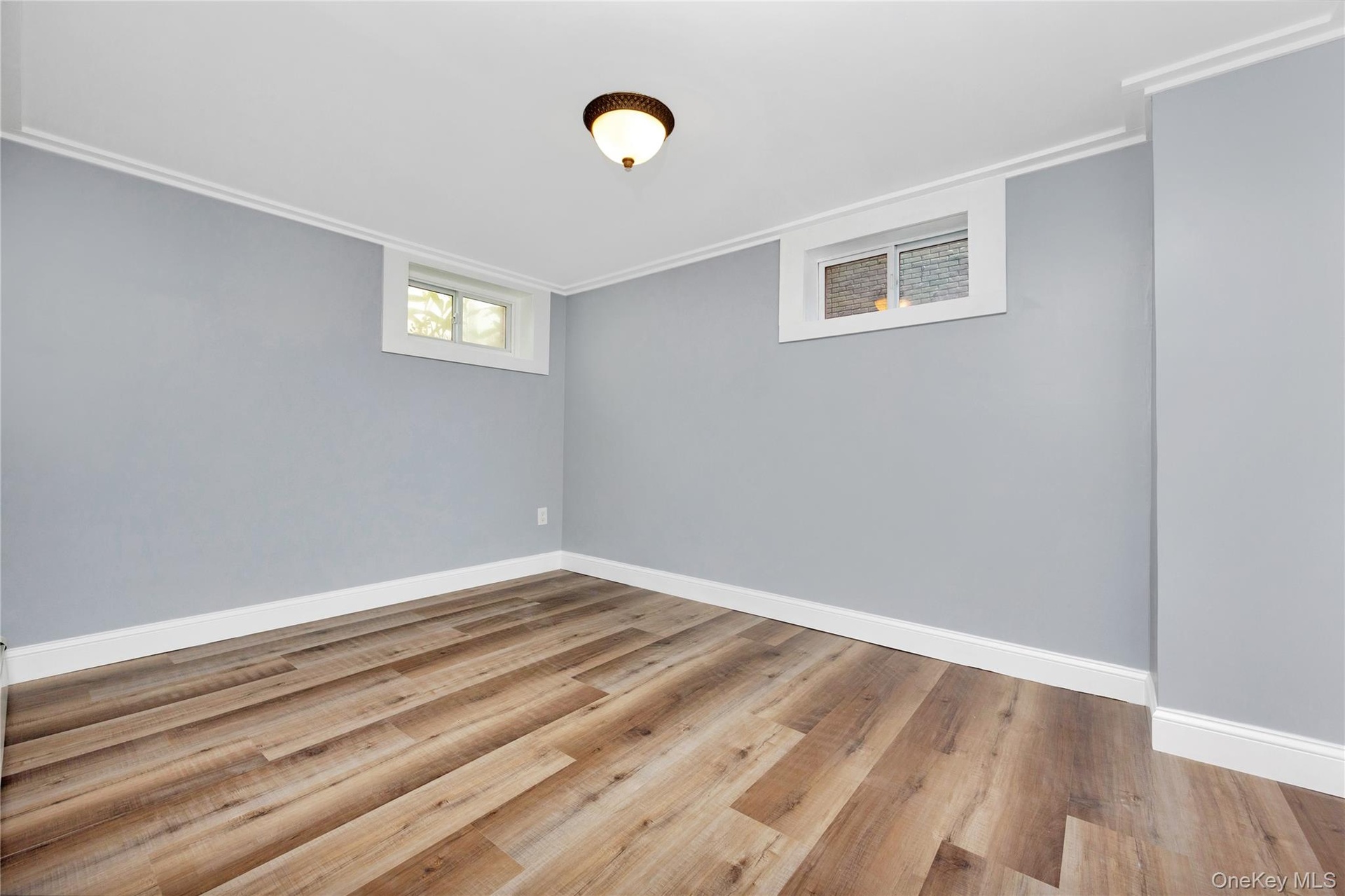 Empty room featuring crown molding and wood finished floors