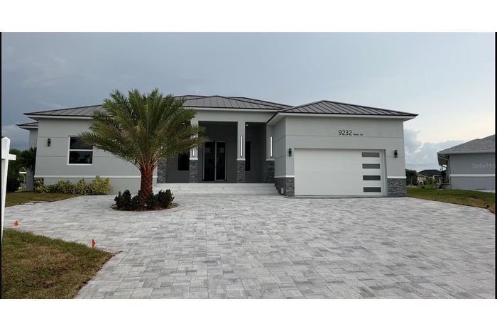 Welcome to 9232 Arrid Cir offering over 3500 sq ft Modern Waterfront Living