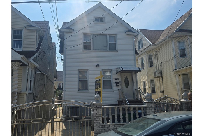 Siding exterior with dormer window and covered entryway