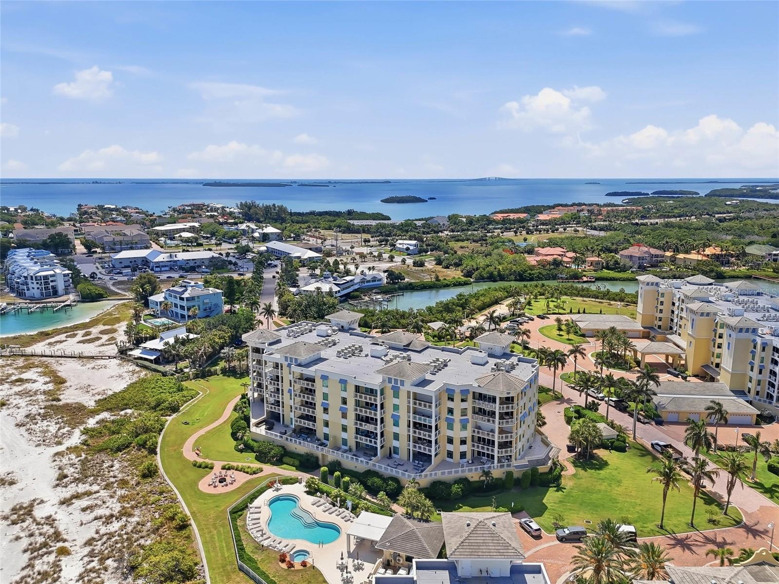 Aerial view highlighting the beachfront location and resort-style pool. Tierra Verde and the beaches close to Fort Desoto is an amazing Paradise!  Liv