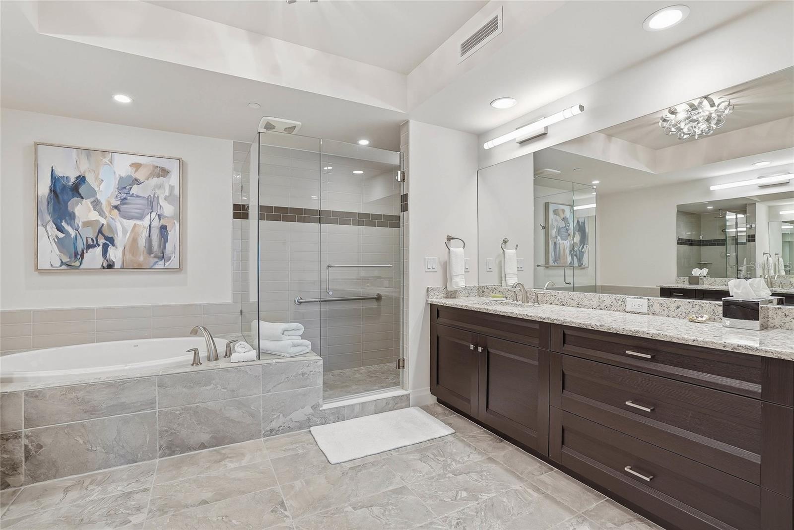 Luxurious primary bath with dual vanities, soaking tub, and walk-in shower.