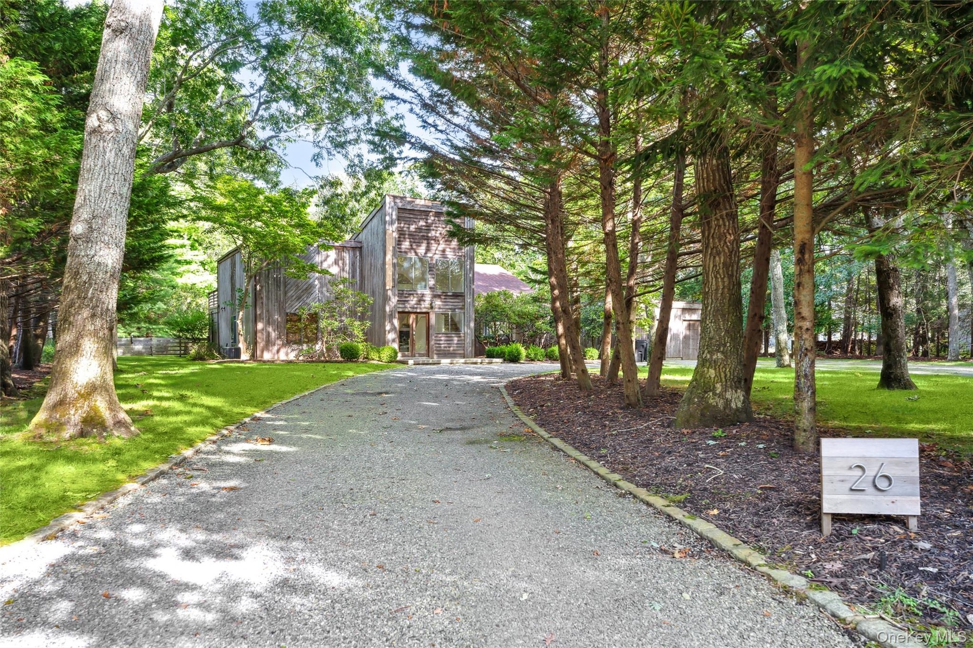 View of property's community with a lawn, driveway, and stairs