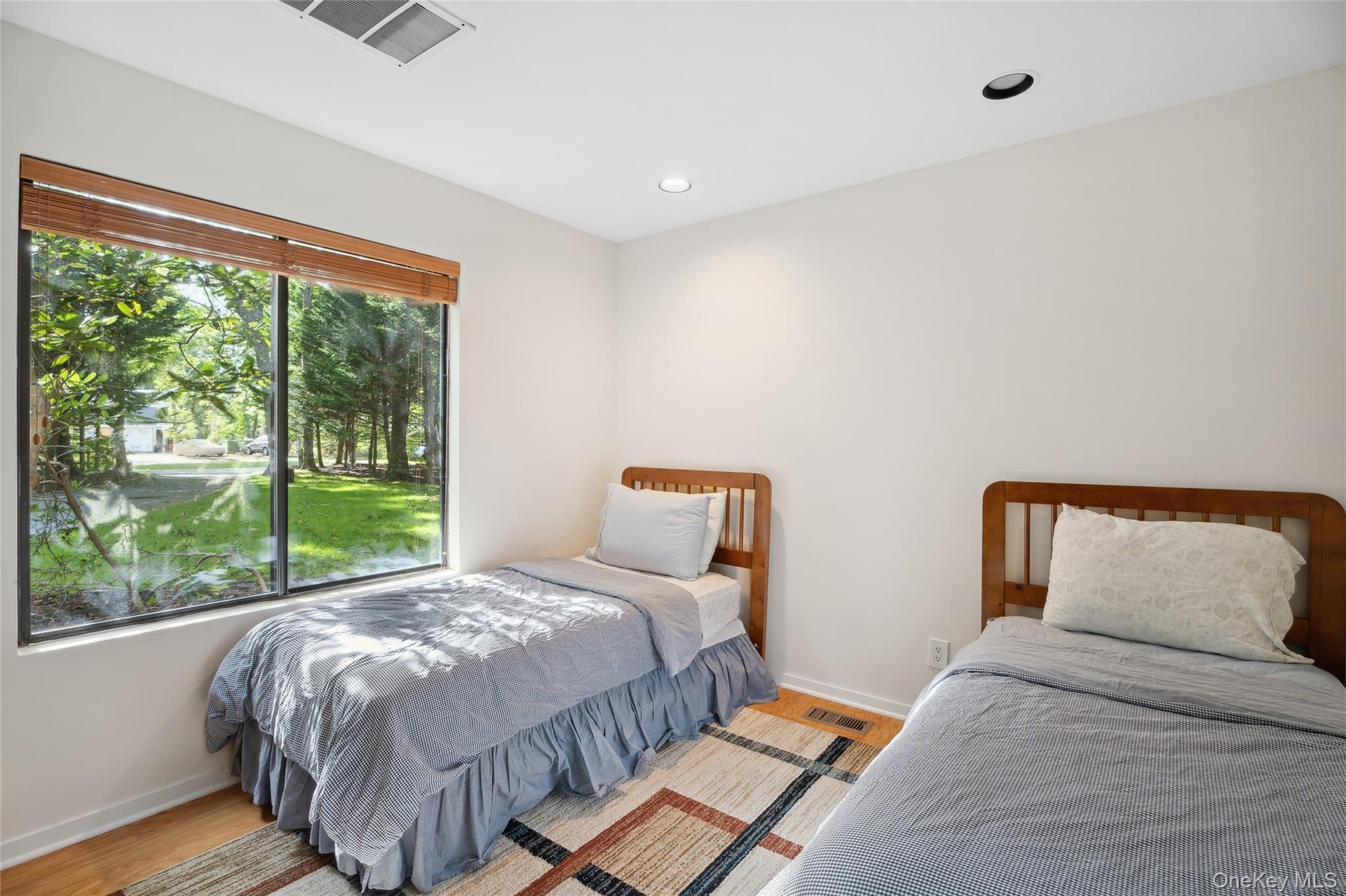 Bedroom with wood finished floors and recessed lighting