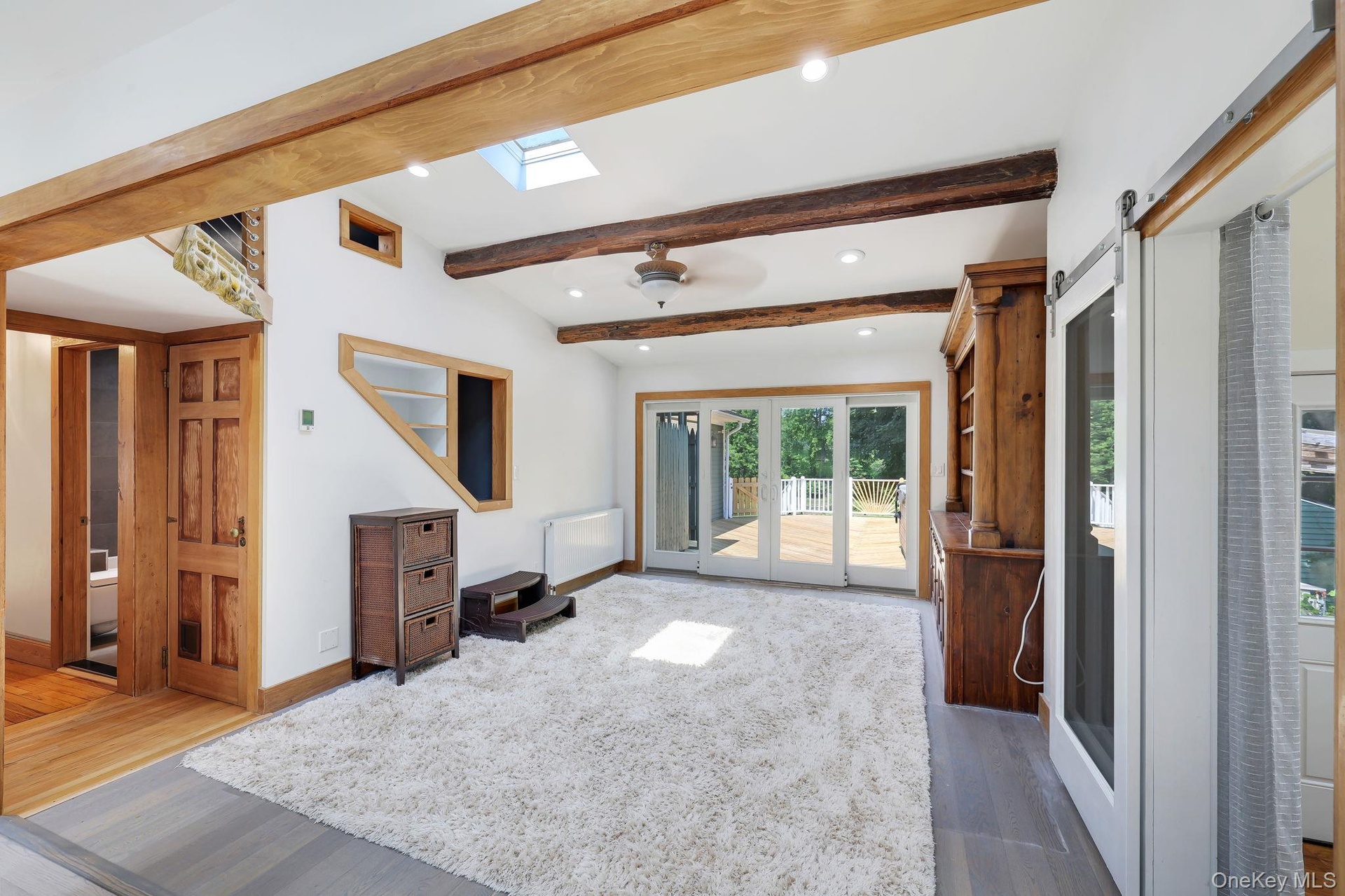 Generous size Family Room with sliding glass doors to back deck with jacuzzi and outdoor shower.