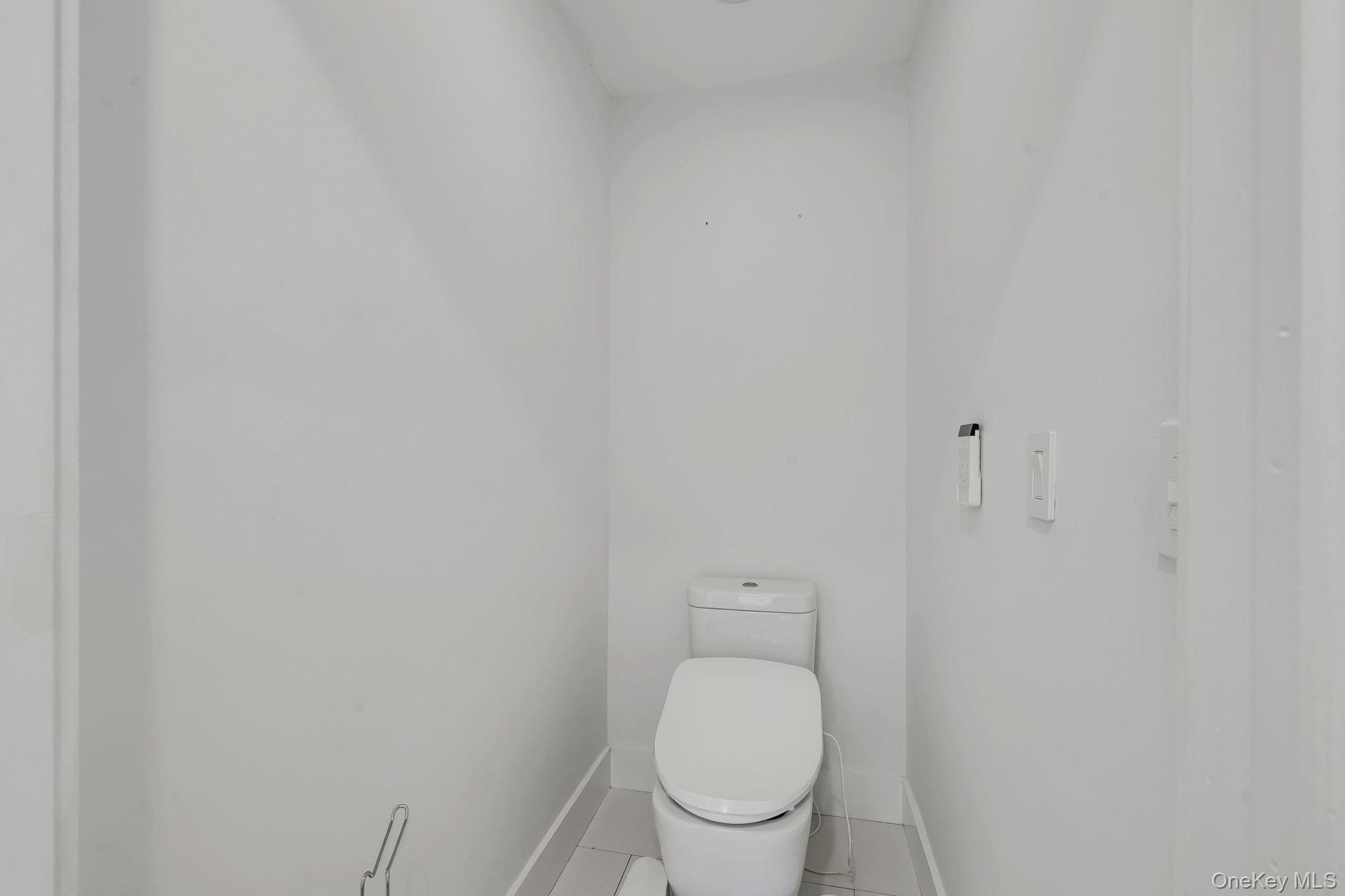 Primary Water Closet with remote to operate comfort features of heated seat and bidet functions