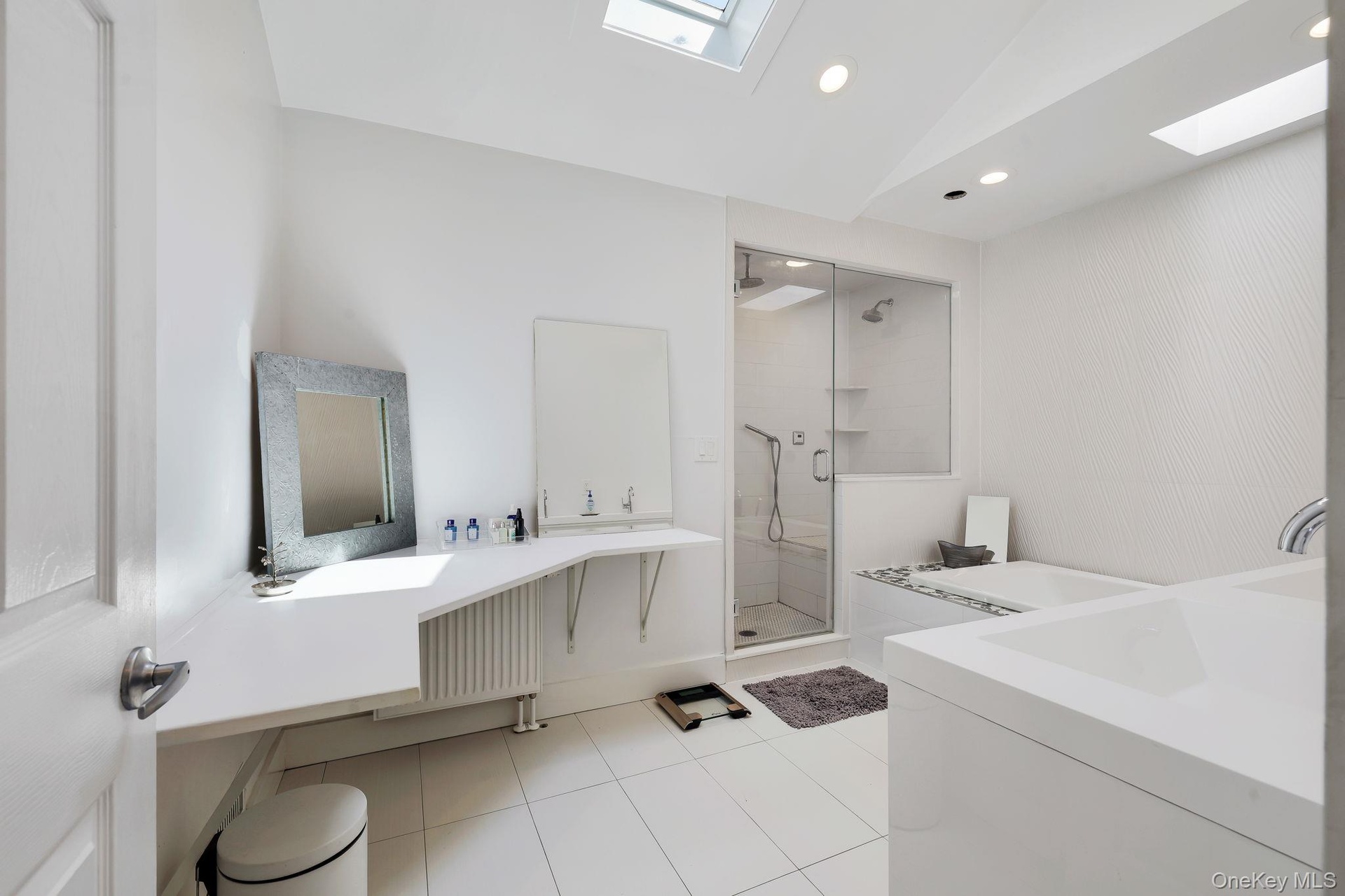 Primary Bedroom En Suite - Plenty of counter space, double vanity and radiant heated tile floor.