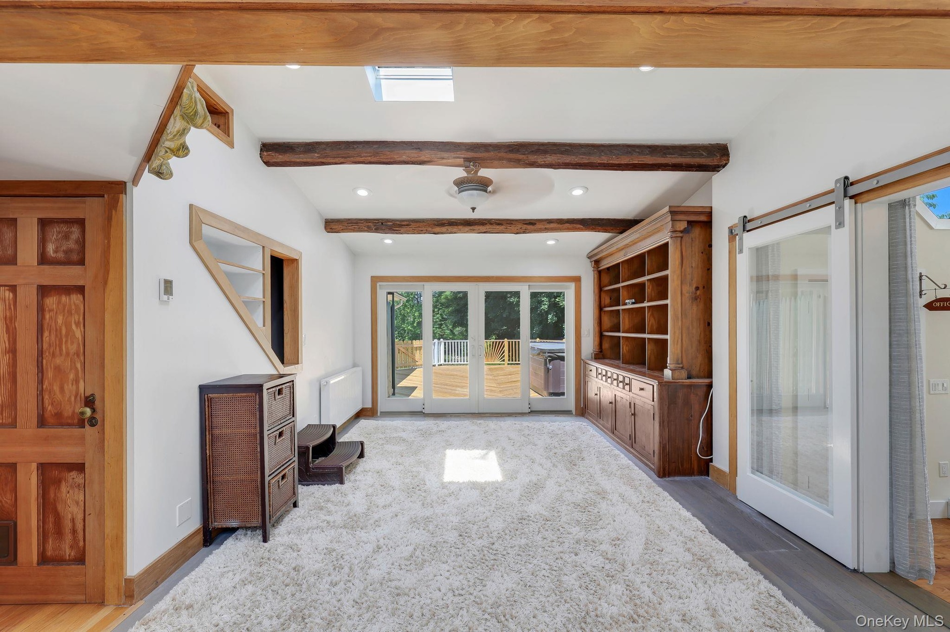 Family Room with sliding glass doors leading to back deck with hot tub and outdoor shower.