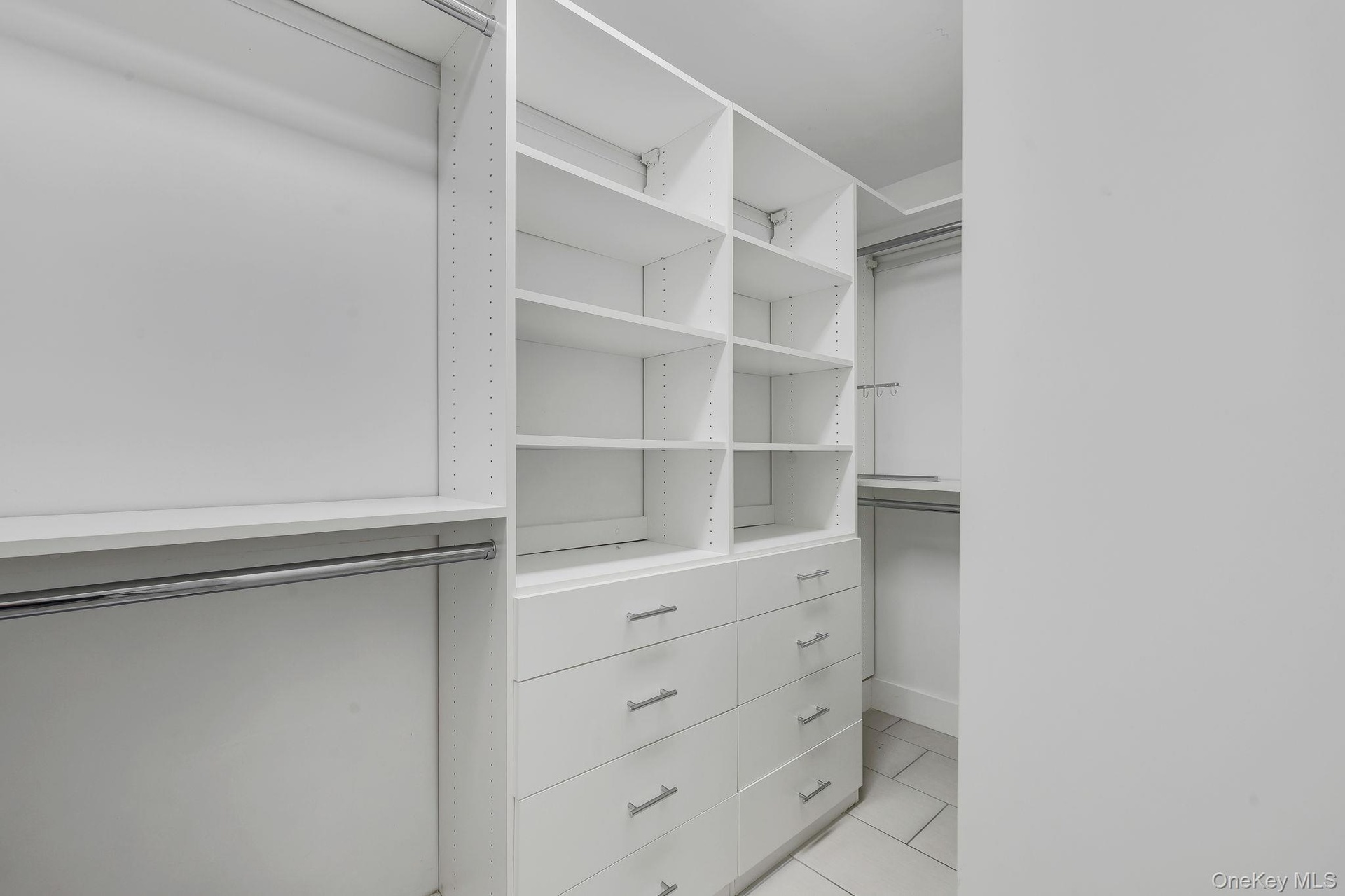 Primary Bedroom walk in closet with built in's and radiant heated floor