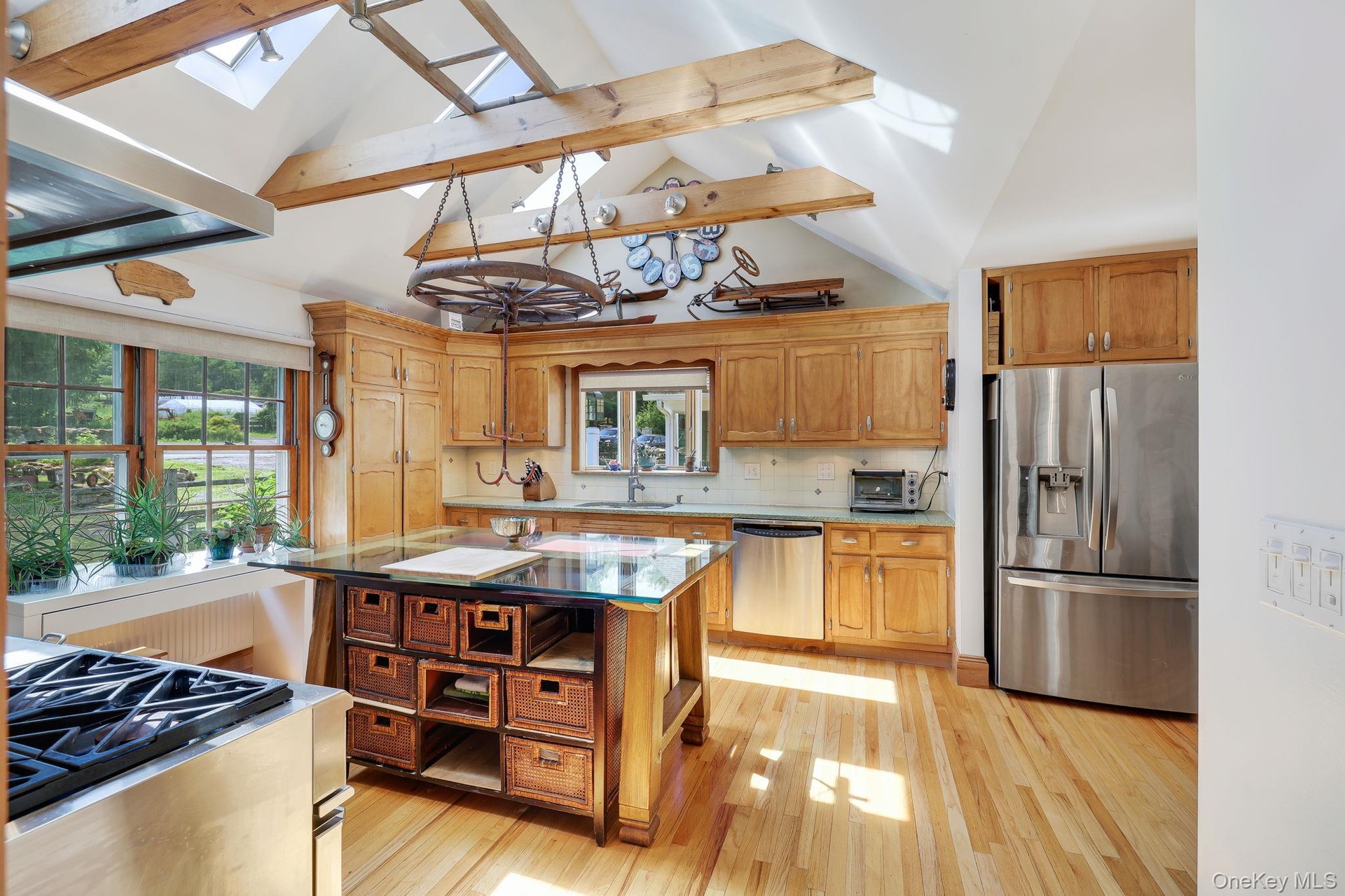 Kitchen with vaulted ceilings,  exposed wood beams and skylights.
