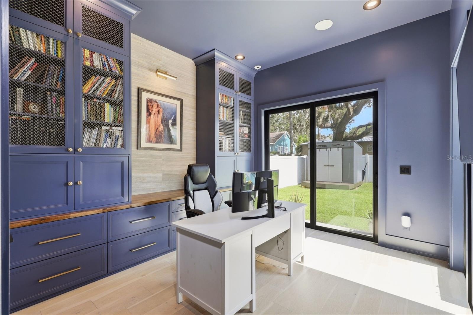 Office / 6th bedroom with custom cabinetry, and direct access outdoor areas