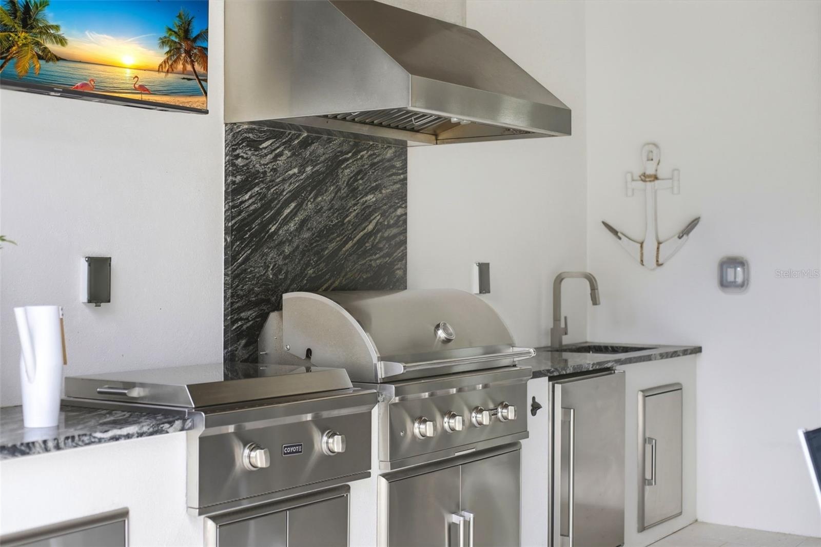 Summer kitchen with 30" Coyote built-in grill and outdoor griddle