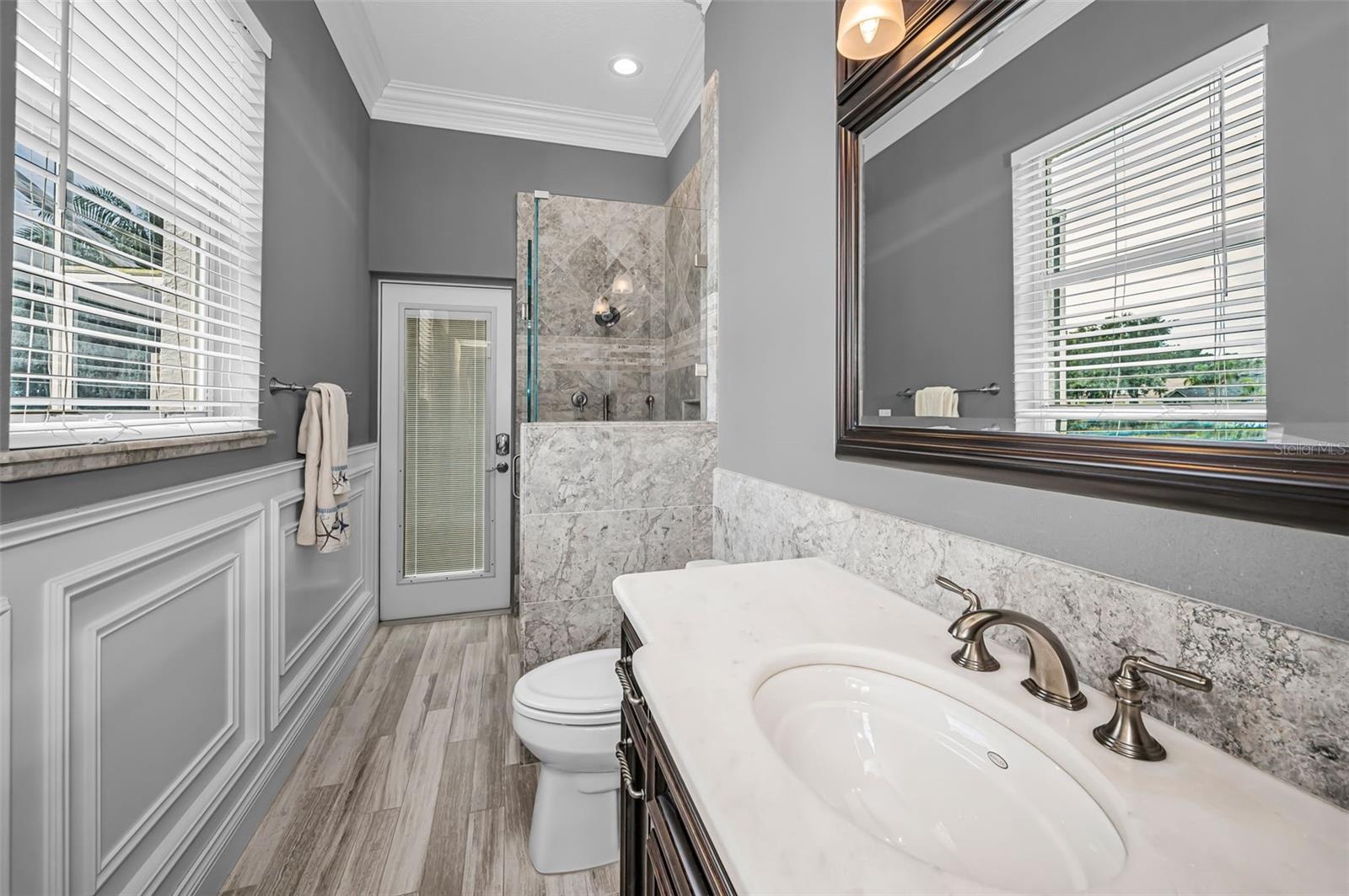 Pool bathroom w/custom cabinetry and glass walk-in shower