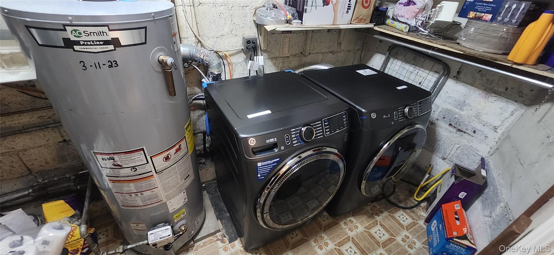 Laundry room with washer and clothes dryer and water heater