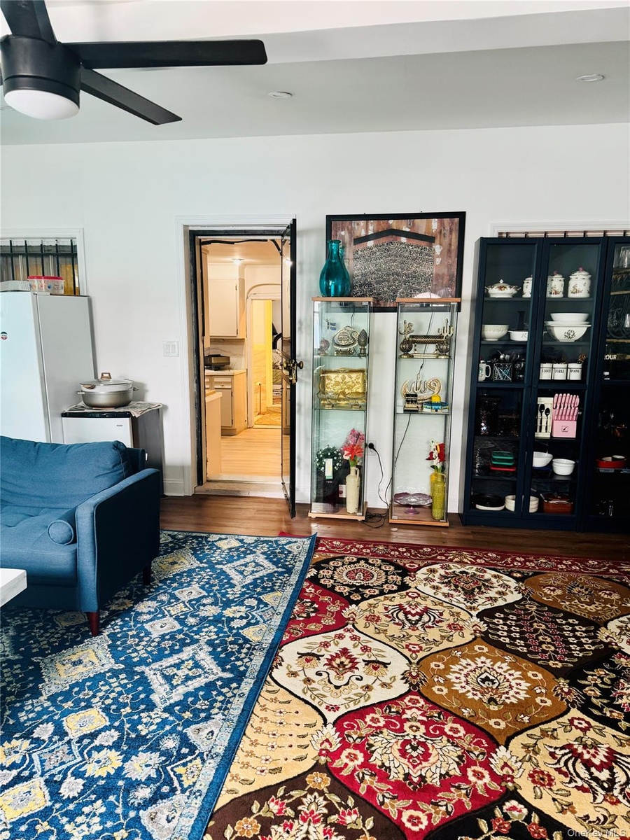 Living room with ceiling fan and wood finished floors