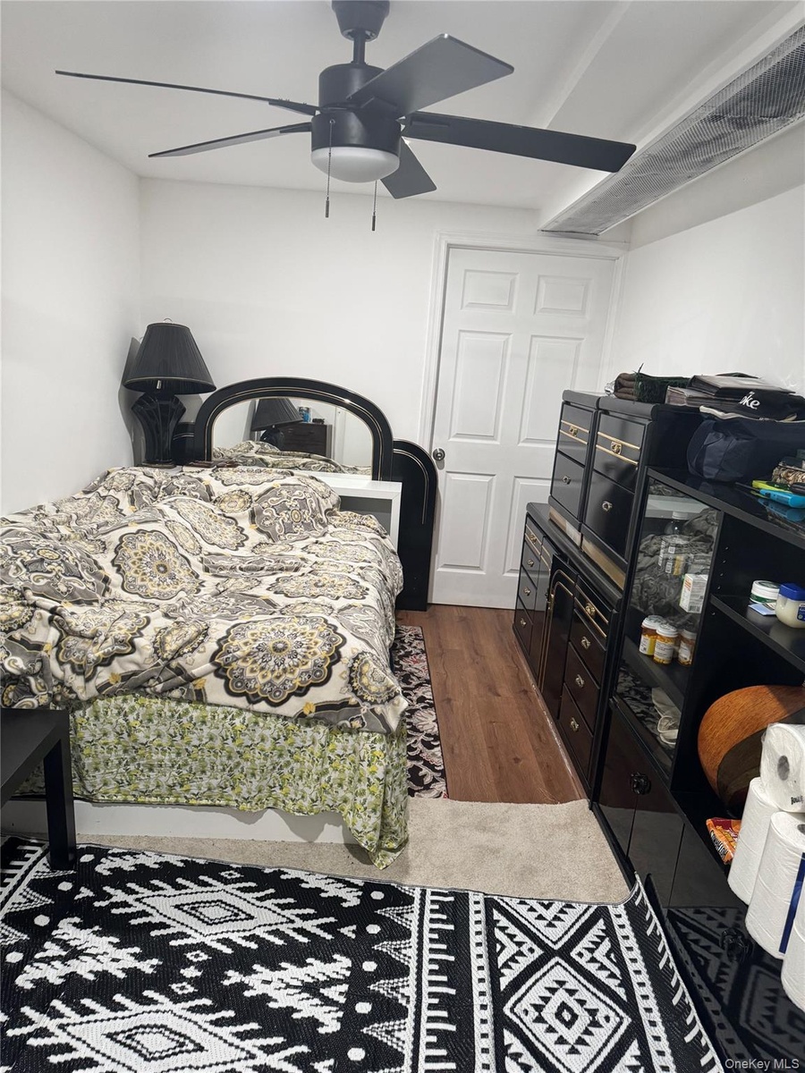 Bedroom featuring wood finished floors and ceiling fan