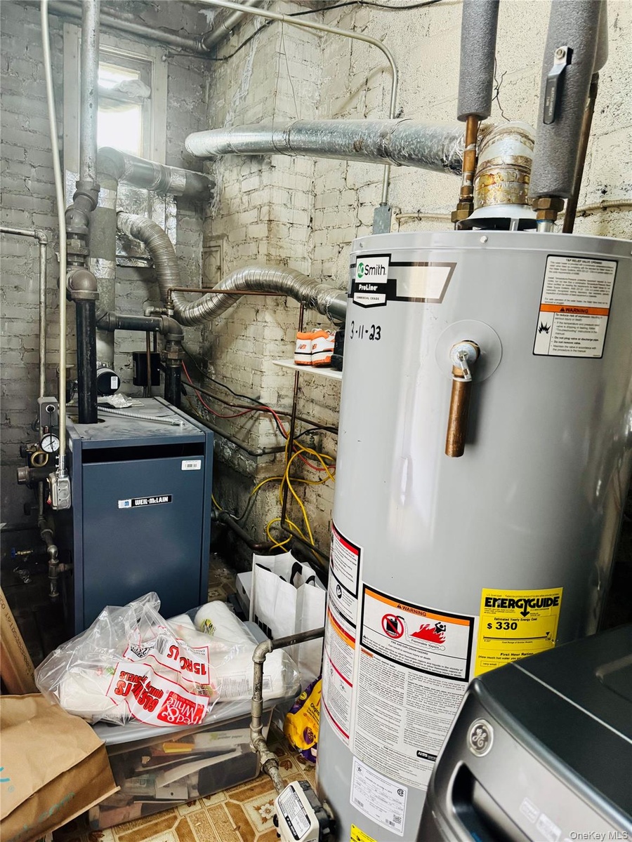 Utilities featuring water heater and a heating unit
