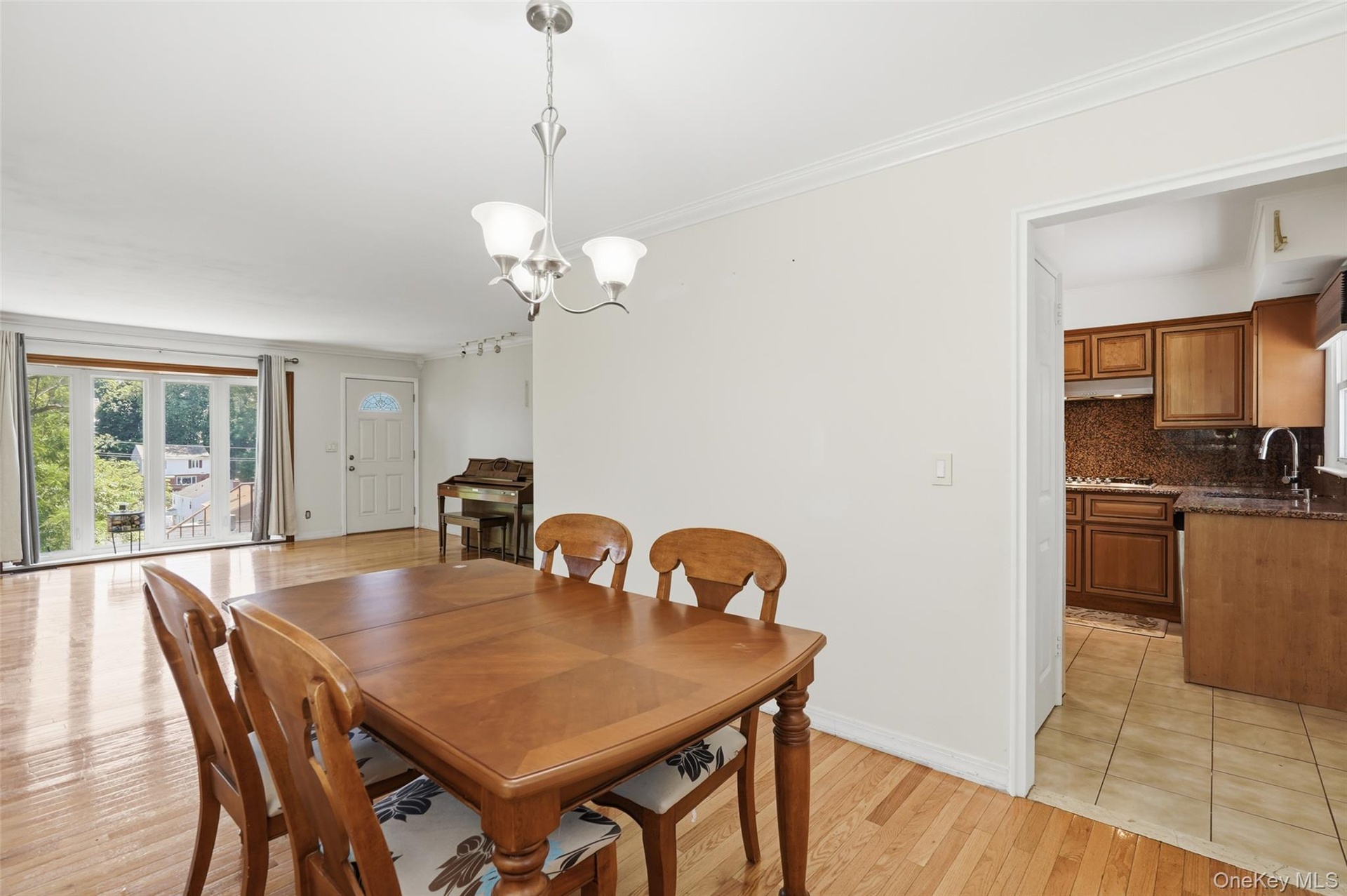 Living room has large picture window allowing for bright morning sunlight.