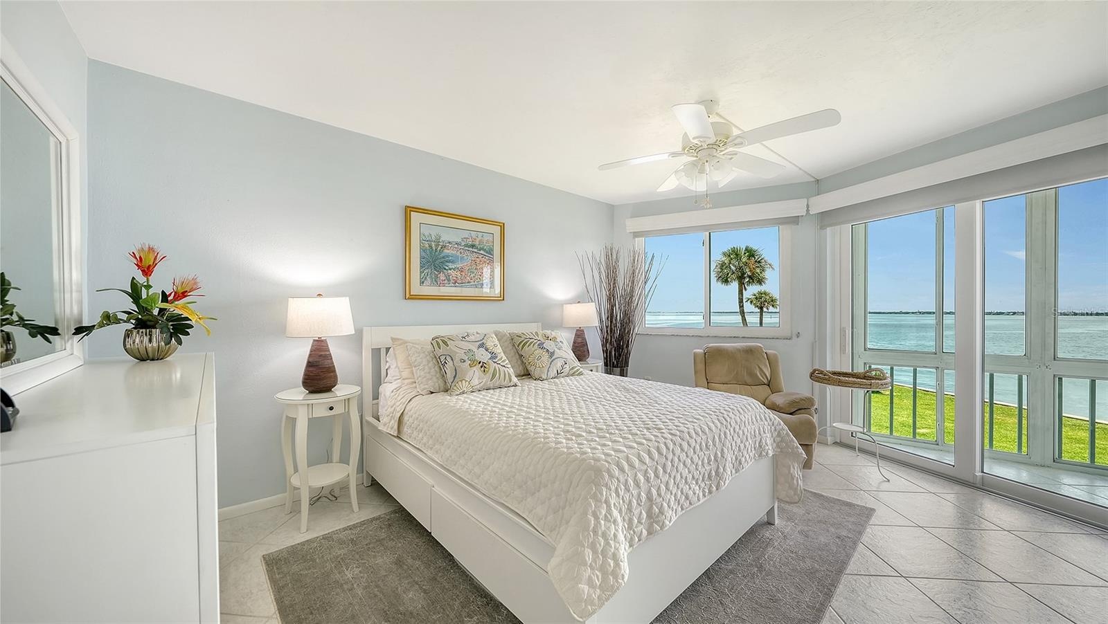 The primary suite enjoys sweeping views of the bay.