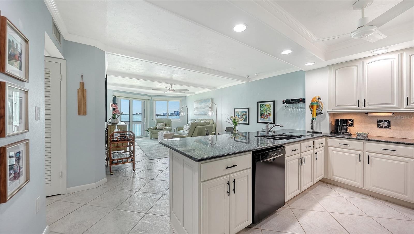 Entry into the condo and the renovated kitchen with granite countertops