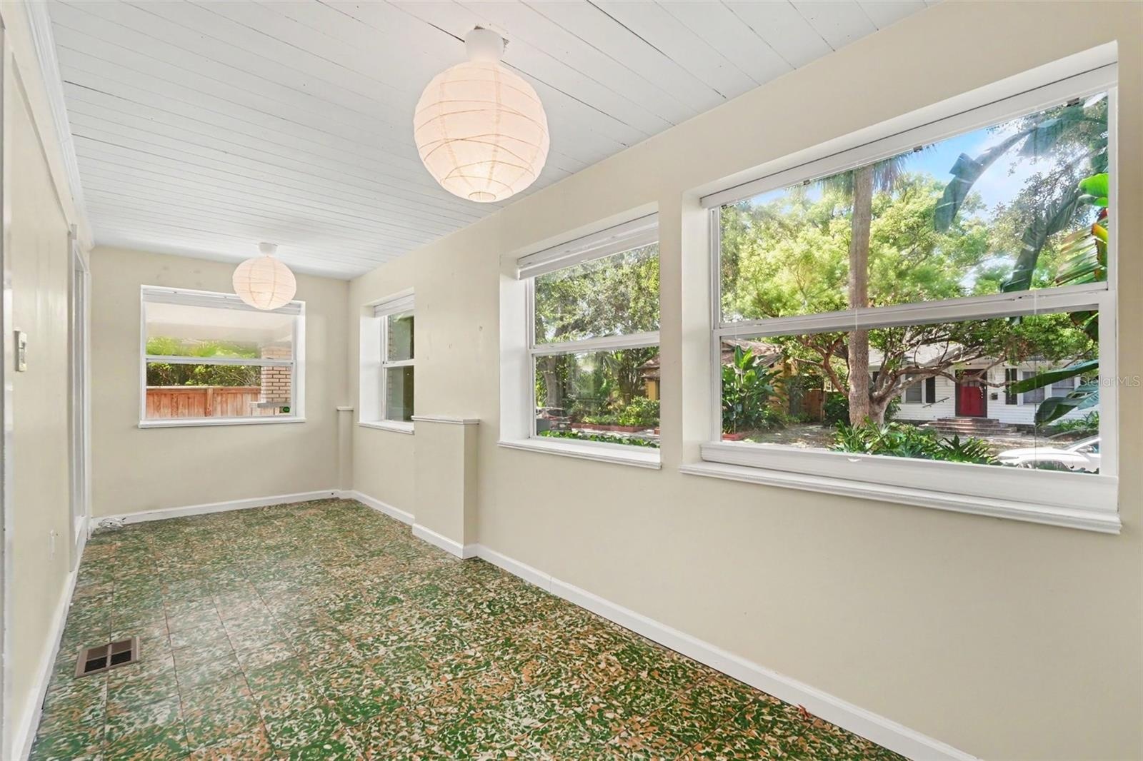 One of the home’s most distinctive spaces, the enclosed front porch features original Cuban tile and endless possibilities for relaxing, reading, or e