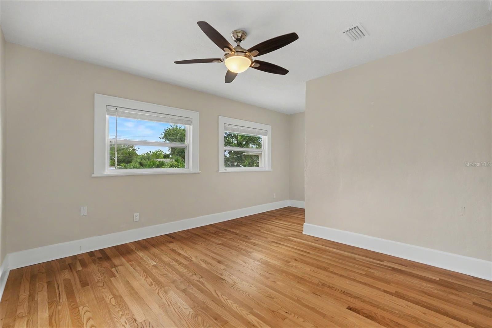 The bedroom offers hardwood floors, abundant natural light, and plenty of room to create a comfortable retreat.