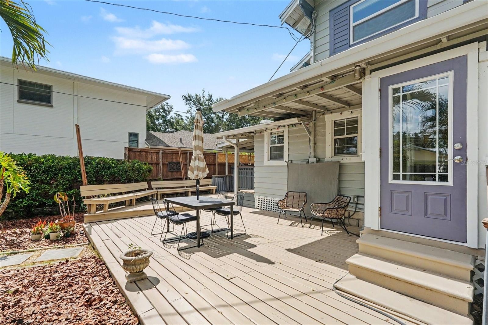 Another view of the expansive deck highlights the multiple seating areas and easy connection between the home and backyard.