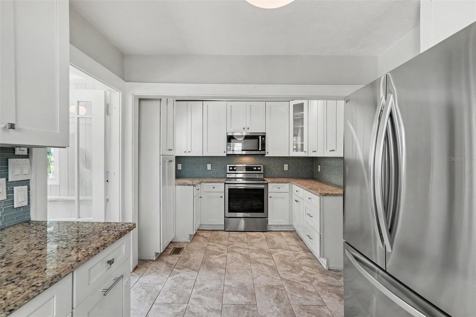 The expanded kitchen offers ample cabinetry, generous prep space, and the functionality needed for everyday living and entertaining.