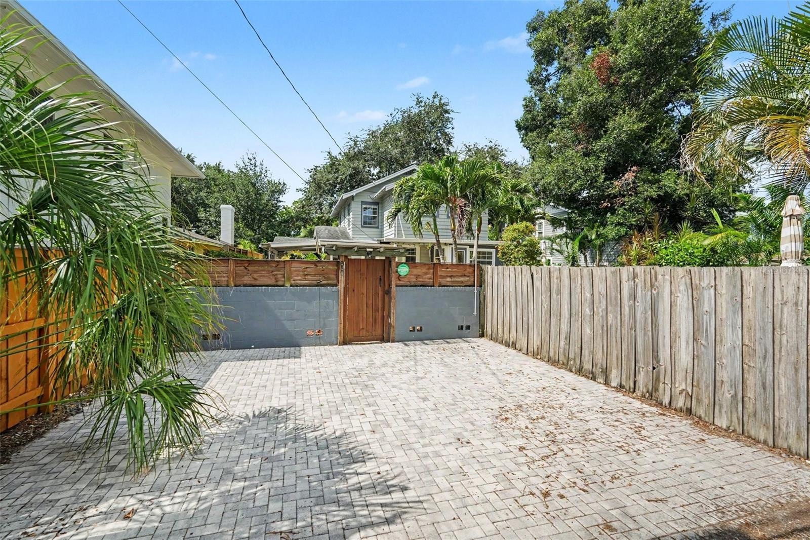 A generous rear parking area provides valuable off-street parking with gated access to the property.