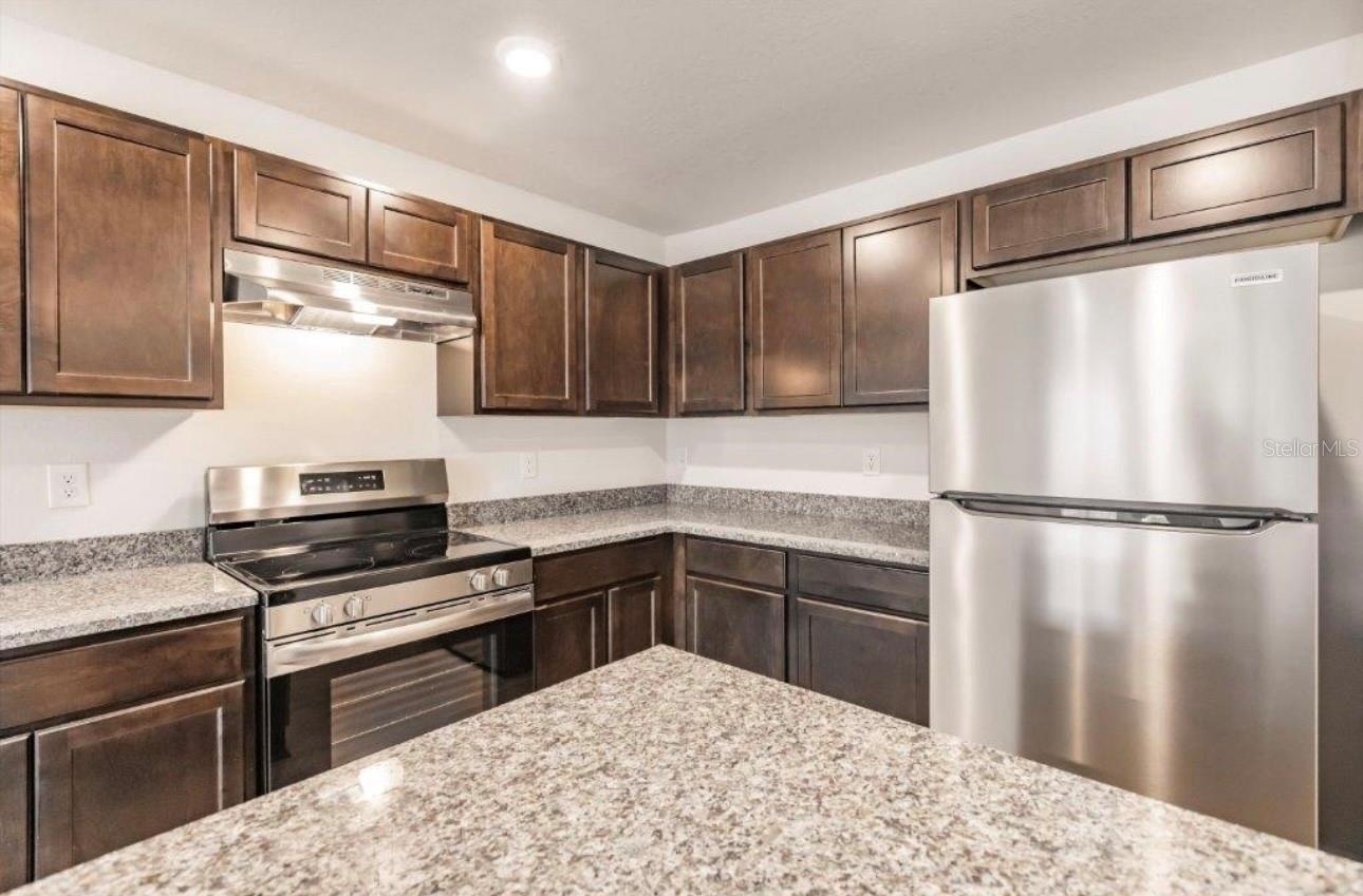 Wood cabinets and stainless steel appliances