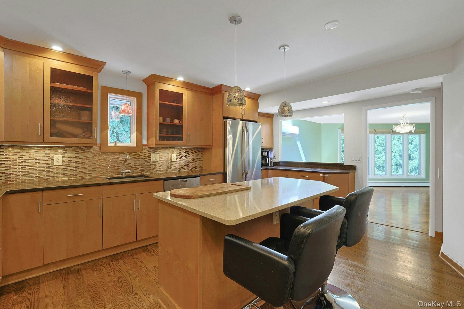 The eat-in island, spacious granite counters and abundant cabinet space should be seen in person to be truly appreciated. The kitchen opens to the din