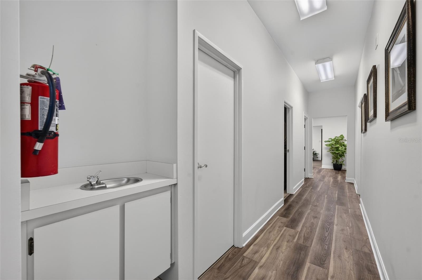 Hallway to annex offices and two bathrooms