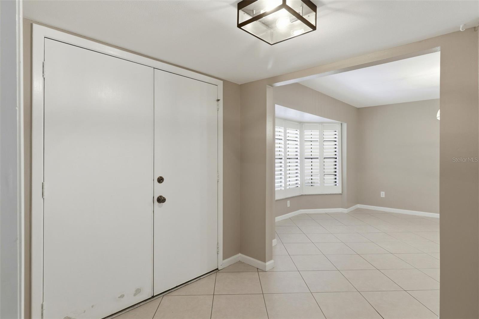 Enter the home through double doors looking into dining room to the left and office/flex room to the right