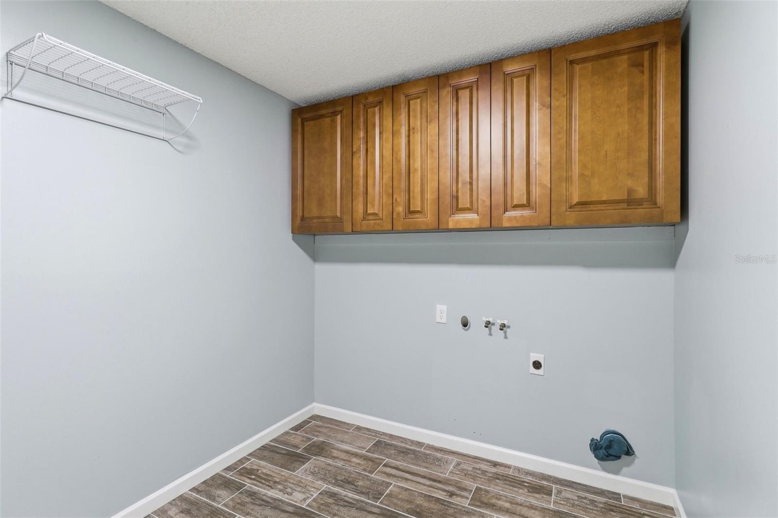 Inside Laundry room with storage and door to garage