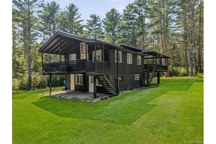 Front angled view, stairs to main level porch and entry door. Lower entry door