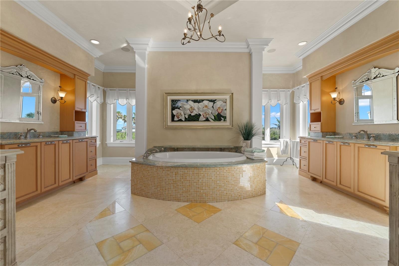 Old World charm meets everyday comfort with separate vanities, intricate mosaic tilework, and a centerpiece soaking tub.