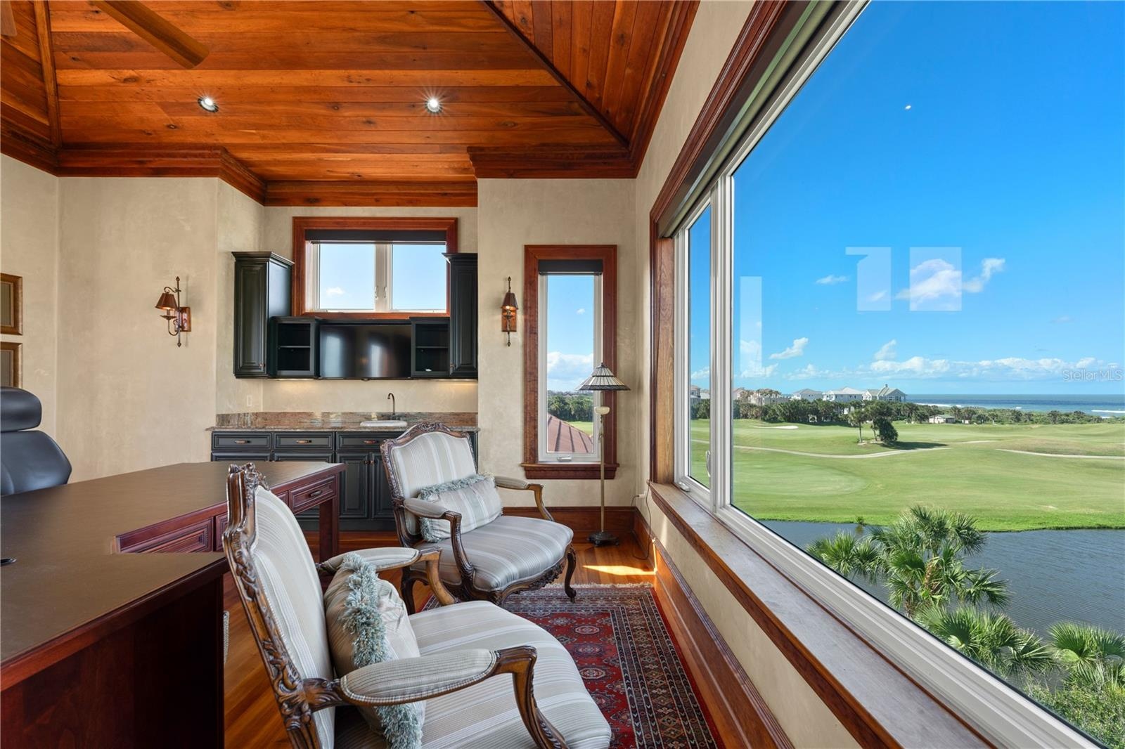 Ascending to the uppermost level reveals one of the home’s most remarkable spaces, a dedicated executive office surrounded by nearly panoramic views c