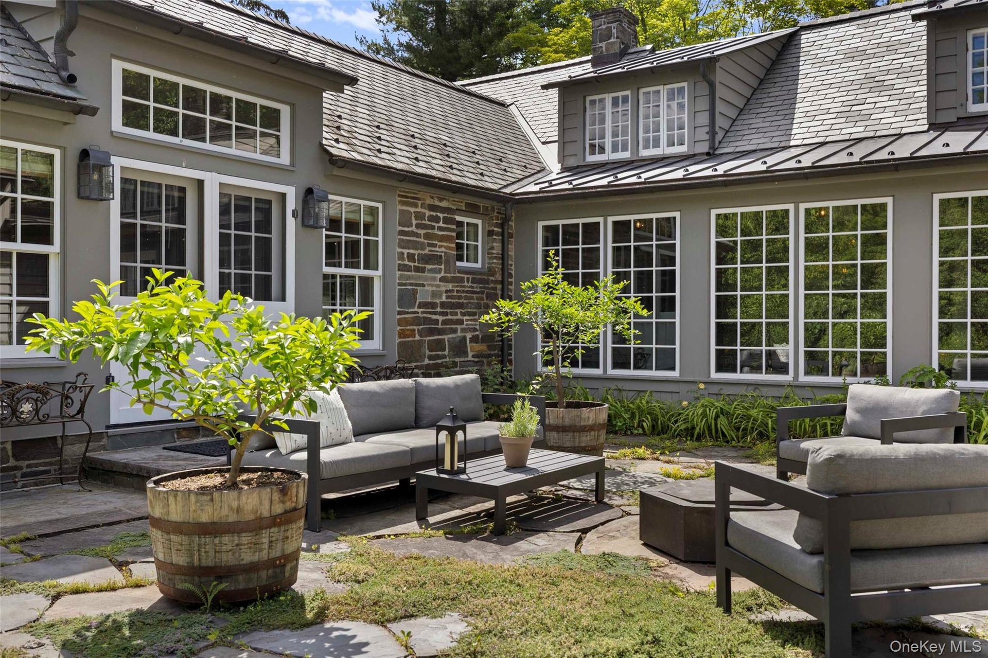 A beautifully landscaped stone courtyard, offering a secluded outdoor setting for entertaining and quiet relaxation
